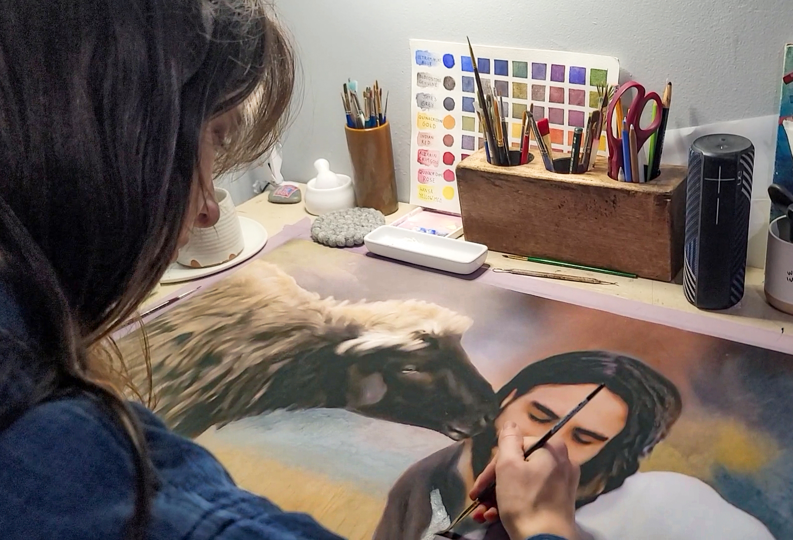 Jordan A. Cook painting The Kiss.