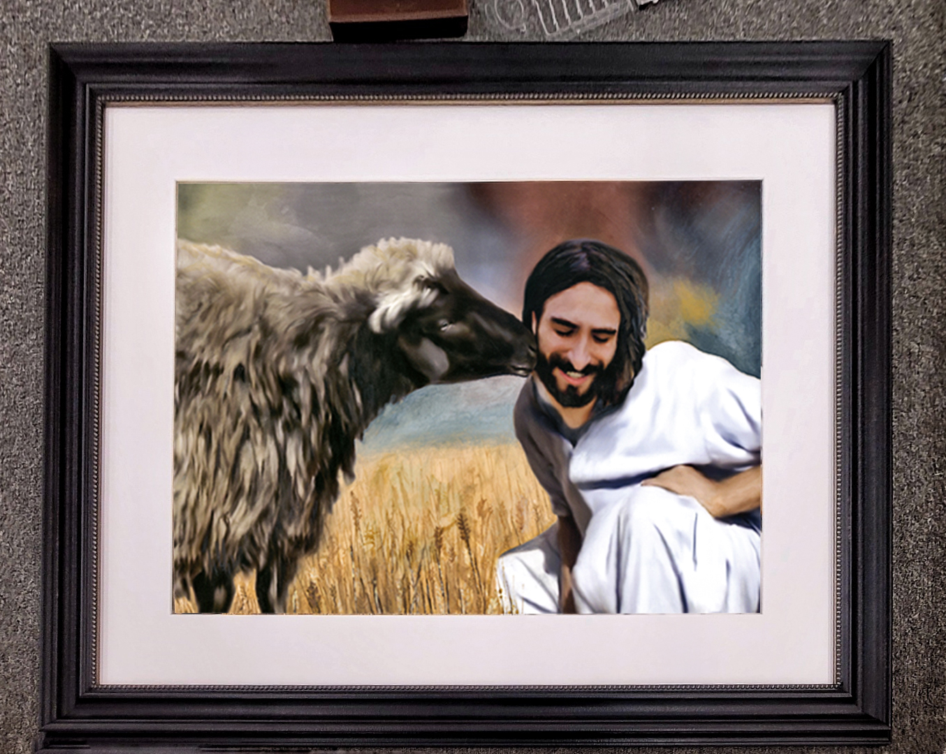 The Kiss by Jordan A. Cook, shown framed.